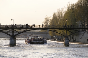 Tourist boat passing under Pont des Arts. Paris