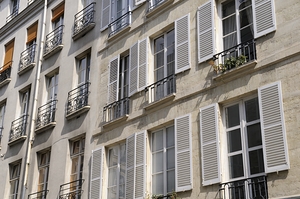 Apartment windows with open shutters and balconies - Paris