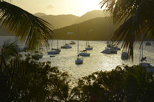 Catamarans and sailboats at the anchorage at Pussers Marina Cay