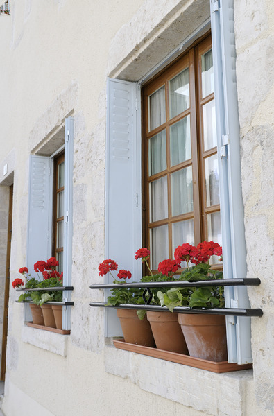 Potted red geraniums in a window Châtillon sur Loire Centre France Print