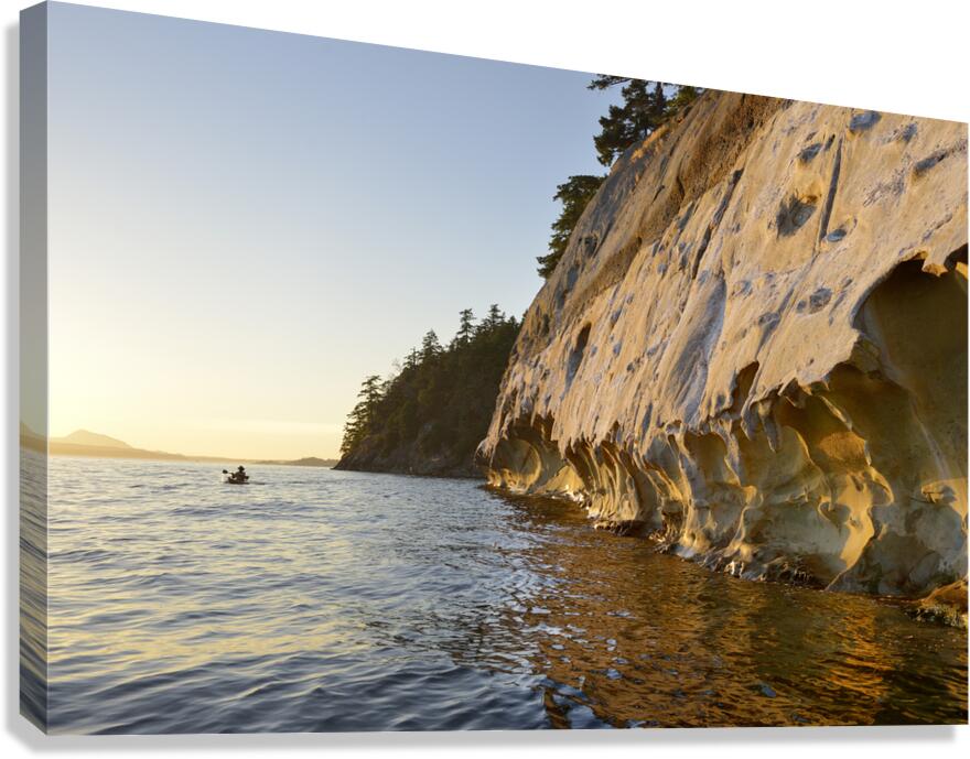 Sea kayaking under the sculpted sandstone cliffs Canvas Print