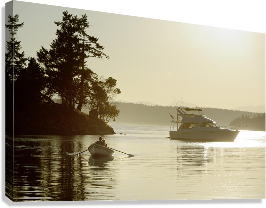 Couple in a dinghy rowing in front of a pleasure motorboat Canvas Print