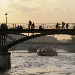 People taking in the view from Pont des Arts. Paris