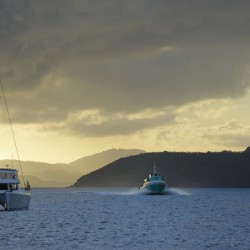 Passenger ferry and anchored catamaran at Sopers Hole
