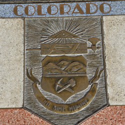 Bas relief plaque for Colorado is inlaid into Hoover Dams plazas surface one of the seven states that fall within the Colorado Rivers basin. Hoover Dam Arizona Nevada USA