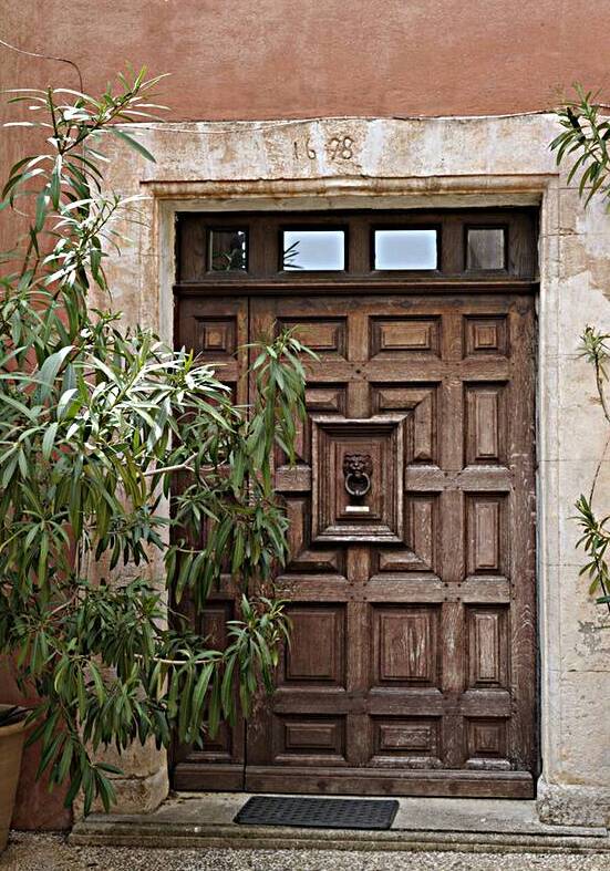Wooden door with door knocker. Roussillon. France by Kevin Oke